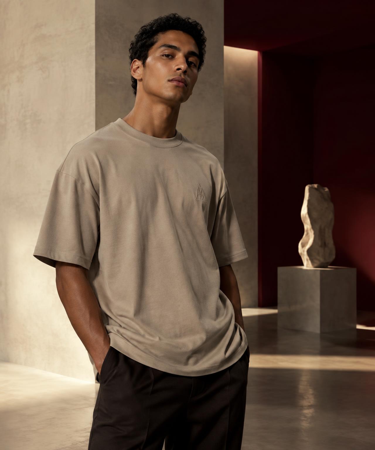 Model wearing a stone oversized A & A T-shirt